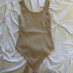 Tan body suit.